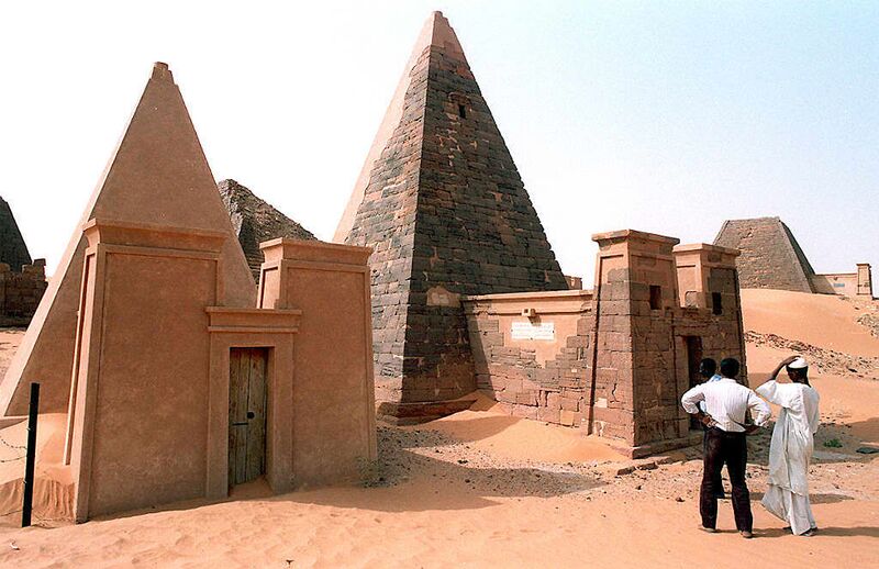 Visitors look at the pyramids of the Sudanese king