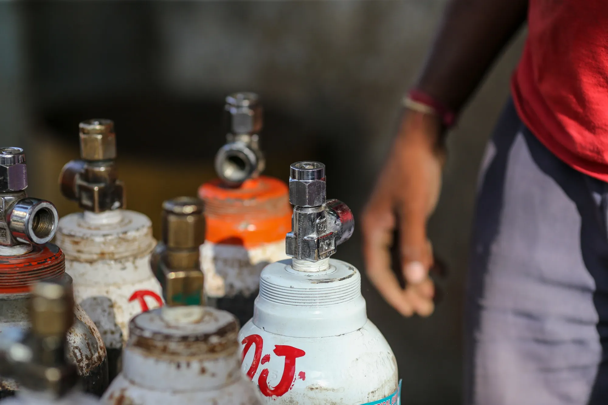 Workers load refilled oxygen tanks at a refill station in Navi Mumbai, India, on April 22.