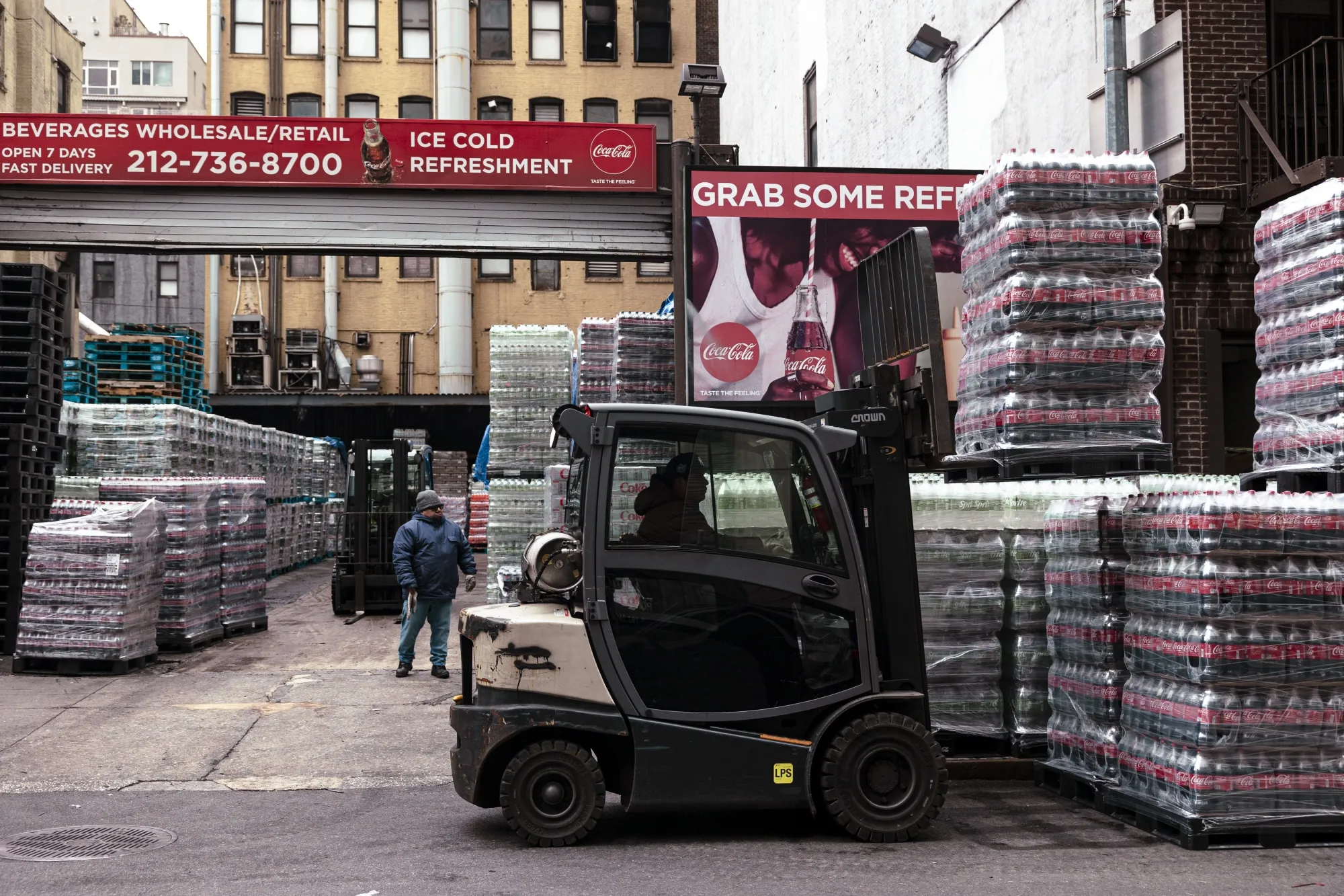A worker moves a pallet of soda outside a beverage distribution company in New York.