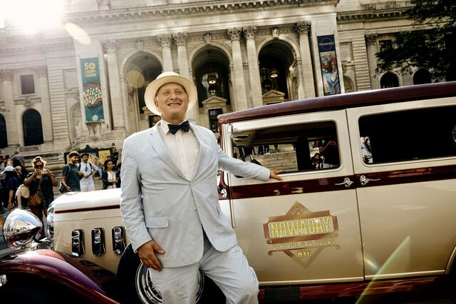 A portrait of Aaron Tabackman in front of a vintage car. 