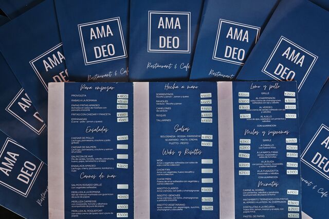 Menus from Ama Deo restaurant arranged in a pile. 