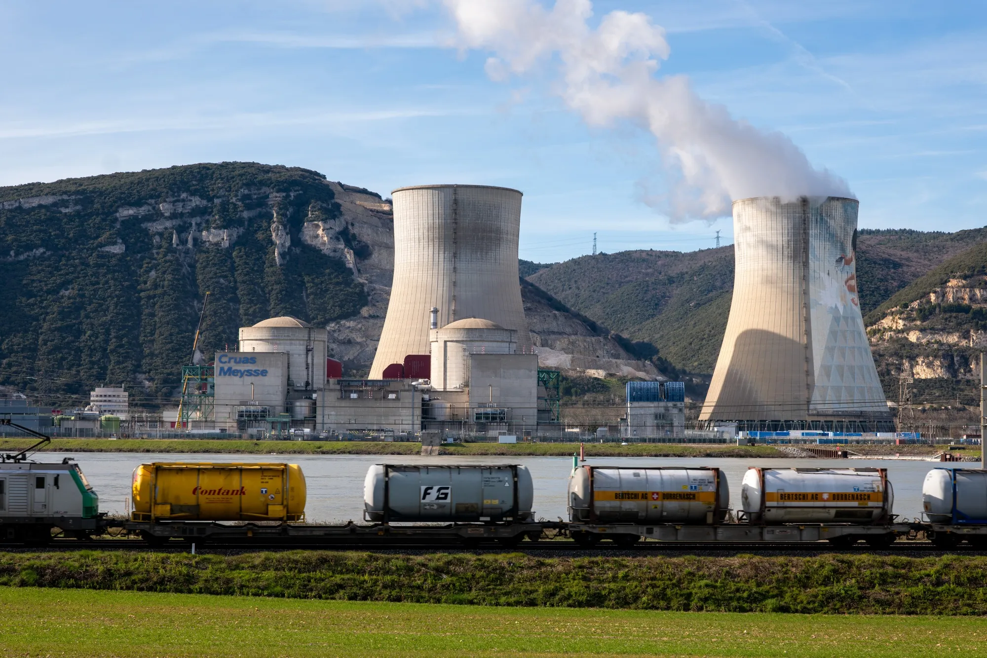 A cargo train passes near a power station near Montelimar, France.
