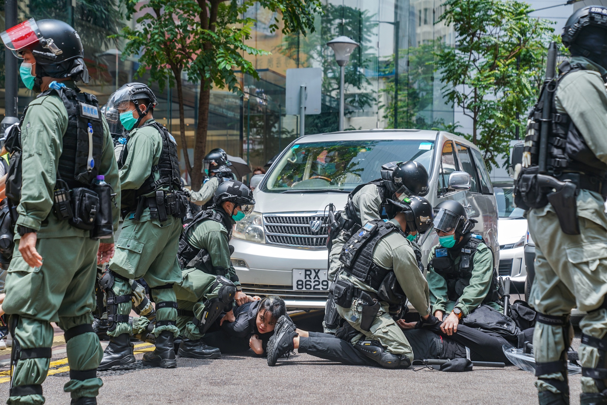 Riot police arrest demonstrators in the Causeway Bay district during a protest in Hong Kong, on May 27.