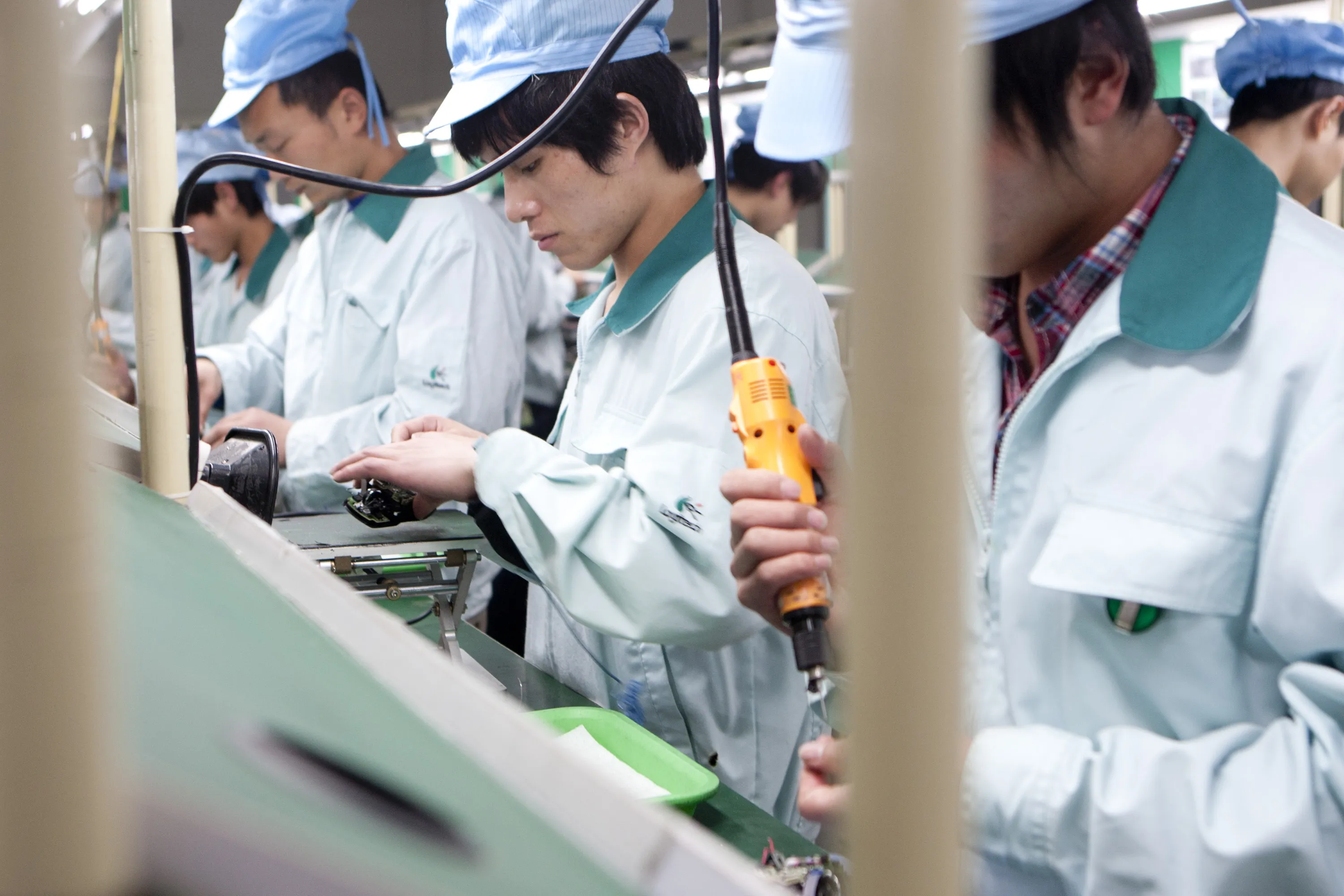 Workers assemble products at the Logitech International SA factory in Suzhou, Jiangsu Province, China. Worker advocates such as China Labor Watch have been critical of Apple suppliers, with reports that workers in China are forced to work unpaid overtime and are operating in unsafe factory environments.
