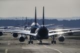 Passenger aircraft operated by Deutsche Lufthansa AG line up after landing at Frankfurt Airport.
