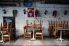 Chairs sit on tables at a closed restaurant in Istanbul.