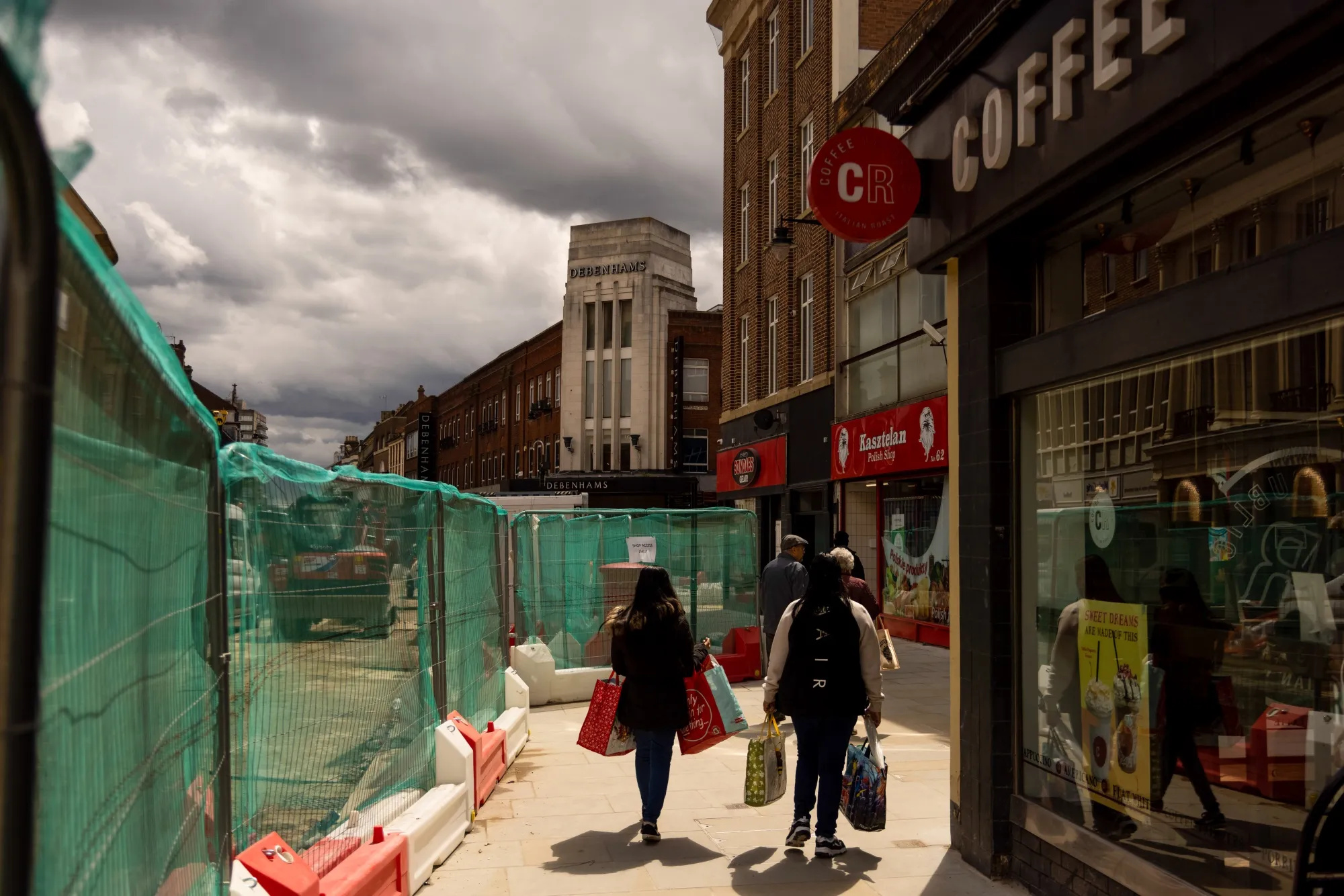Shoppers carry bags in central Bedford, U.K.