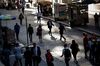 Pedestrians walk along Wall Street near the New York Stock Exchange (NYSE) in New York, U.S., on Friday, Oct. 5, 2018. A severe sell-off in technology stocks has pushed the front-month VIX futures contract to a premium relative to the second-month contract.
