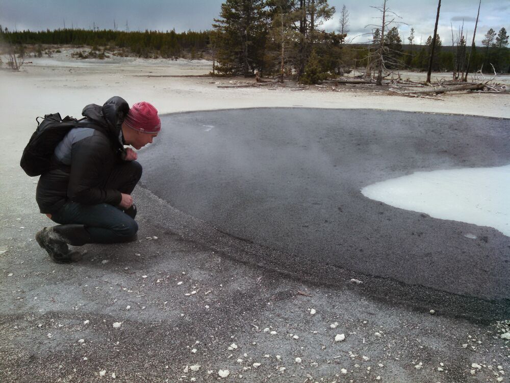 Sustainable Bioproductsâ CEO Thomas Jonas examines a volcanic spring in Yellowstone National Park.Â