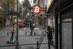 A bitcoin logo sign protrudes from a cryptocurrency exchange kiosk in Istanbul, Turkey.