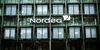A logo sits on display outside the windows of a Nordea Bank AB office in Copenhagen, Denmark, on Tuesday, March 14, 2017. Denmark has changed the way it conducts monetary policy in response to a 2015 existential crisis, according to Danske Bank A/S, the country’s biggest lender.