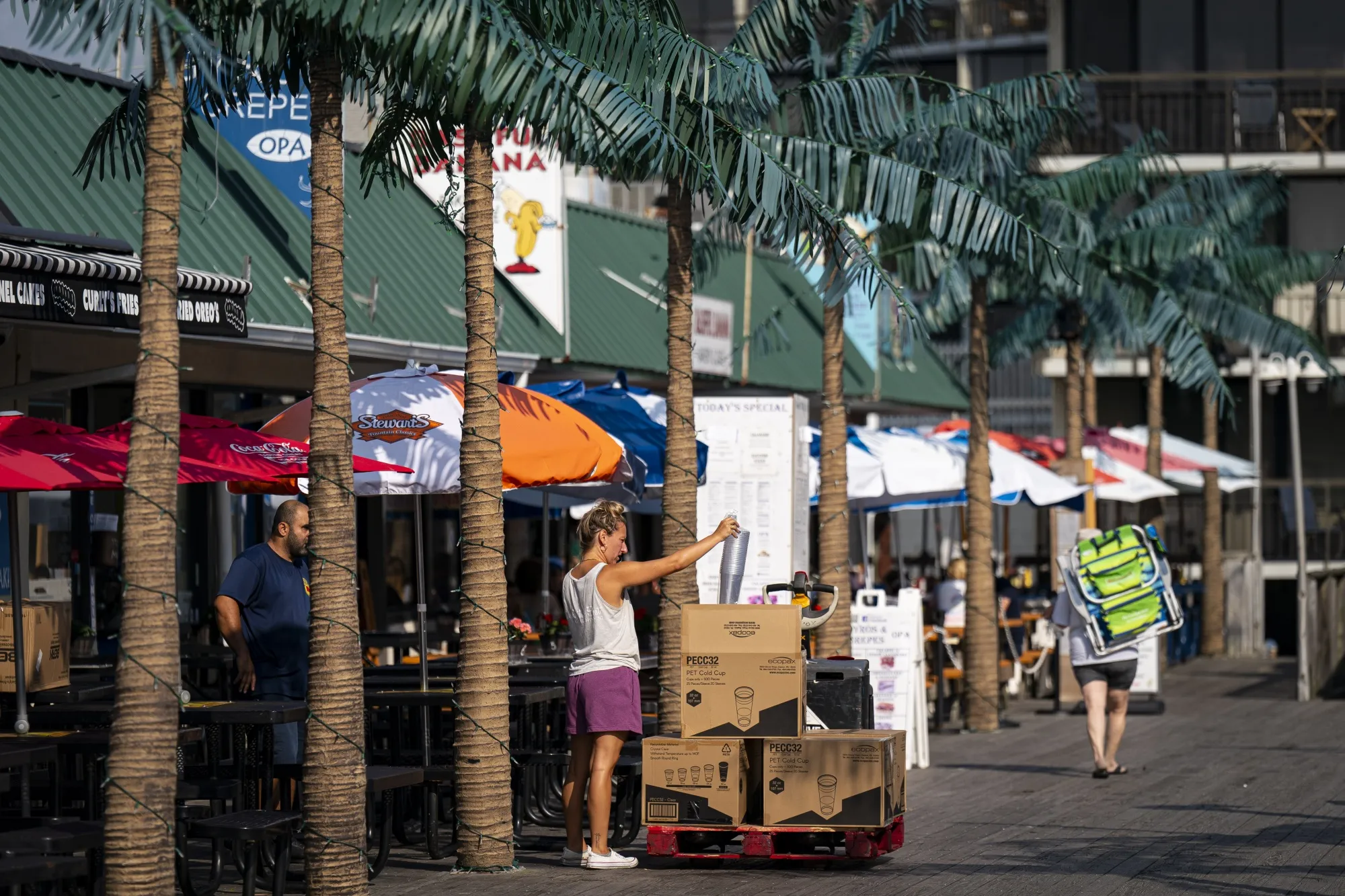 A worker inspects a delivery on the boardwalk in Ocean City, New Jersey, US.