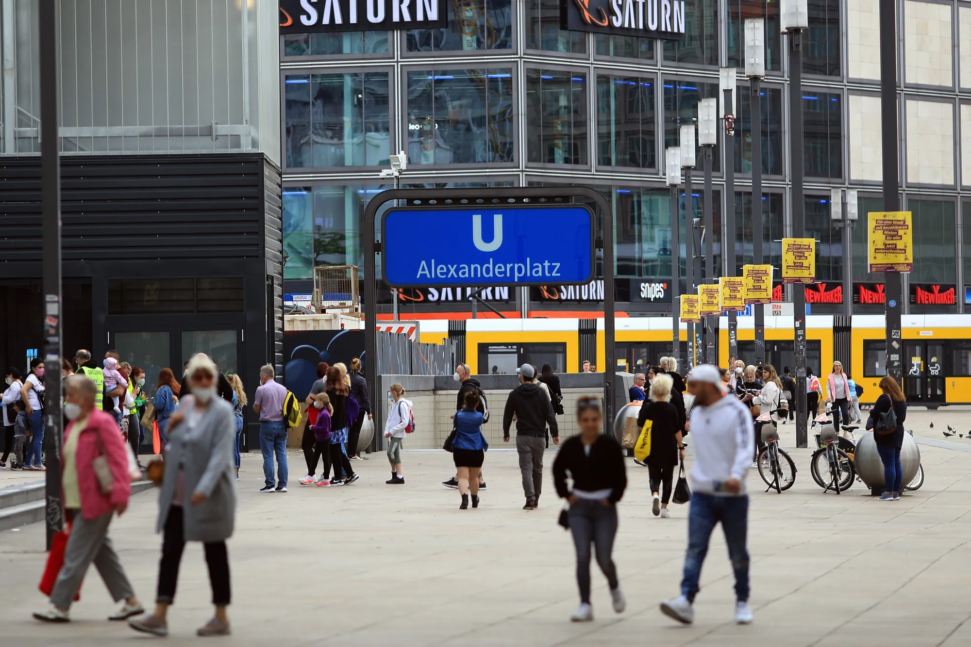 Pedestrians near the U-Bahn underground railway entrance in Alexanderplatz square in Berlin.