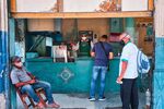 Customers wait to purchase drinks in Havana. Cuba saw unprecedented street protests over shortages of basic goods in July 2021.