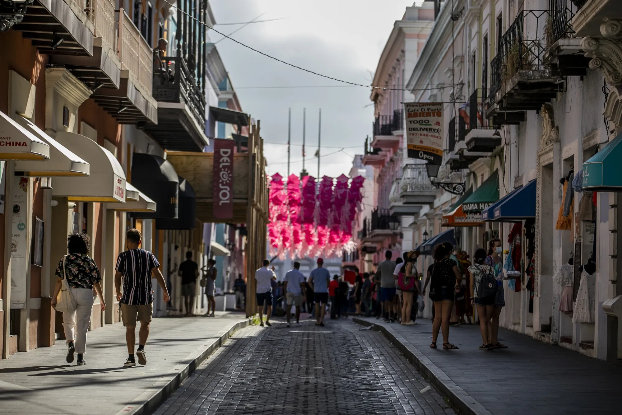 Pedestrians walk through the Old San Juan.