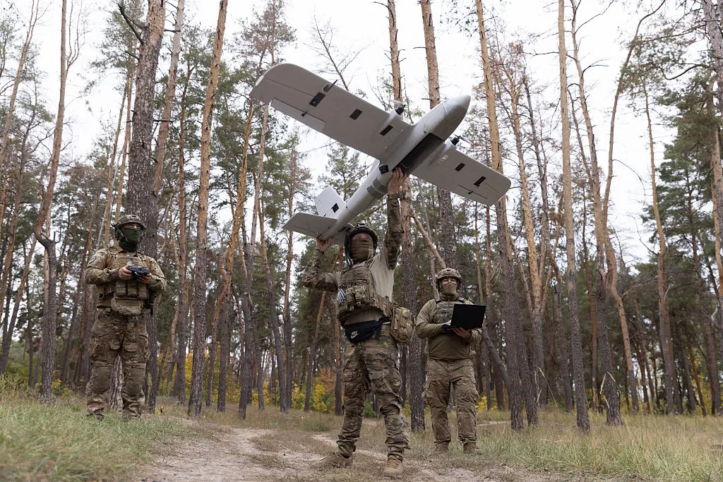 Ukrainian troops prepare to launch a drone.
