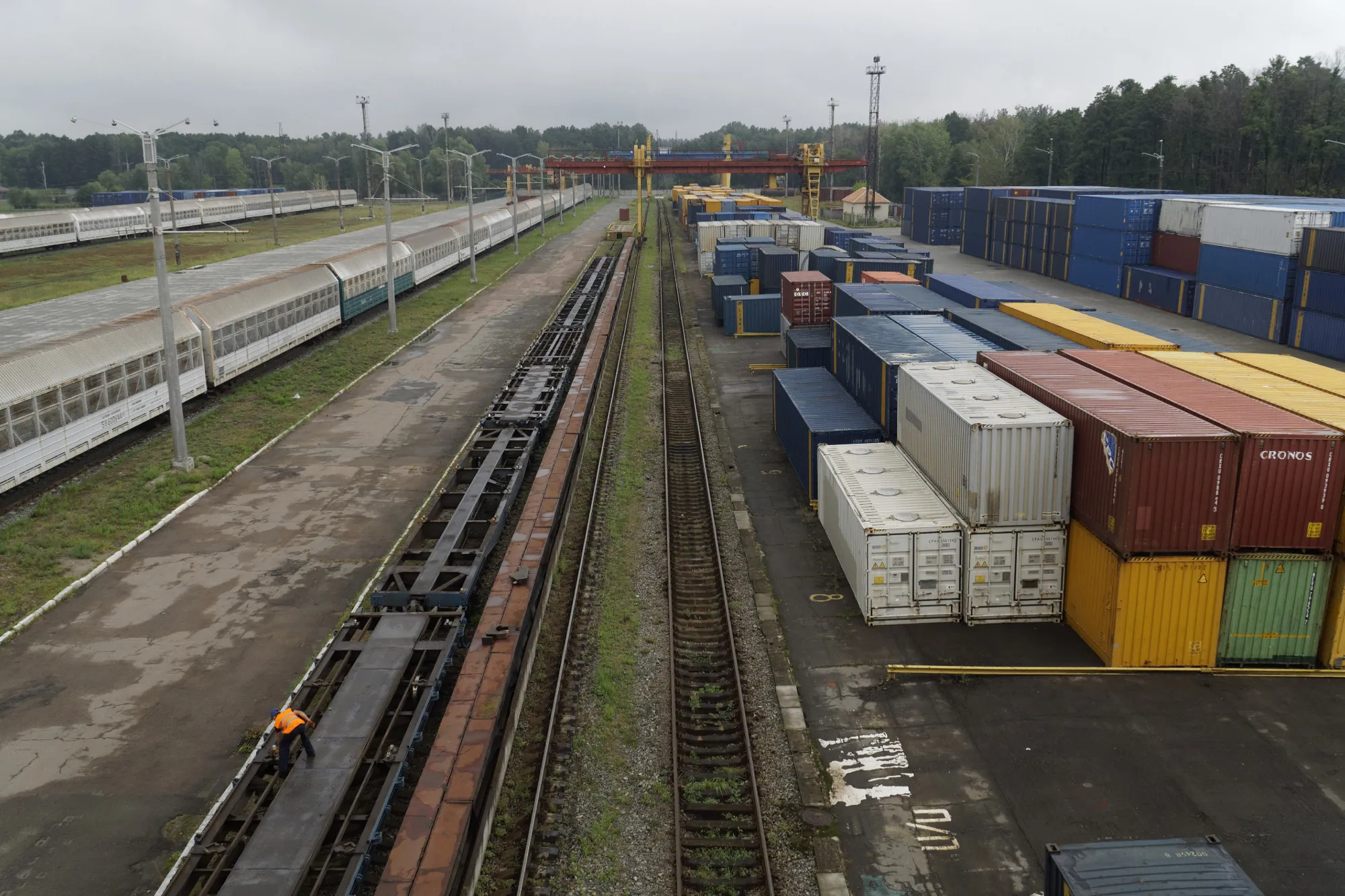 Shipping containers sit stacked beside freight wagons at a railyard operated by&nbsp;Ukraine's state railway, in Kiev, Ukraine, on Thursday, Aug. 18, 2016.