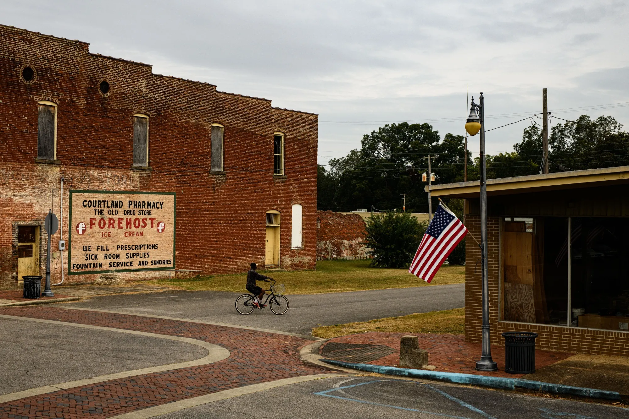 A man rides a bicycle through downtown Courtland, Ala. on Thursday, Oct. 5, 2023.