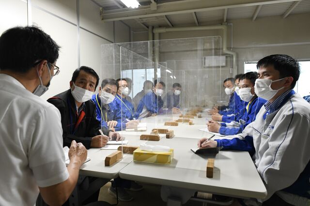 Japanese workers and Vietnamese trainee workers during a meeting at Kushiro Coal Mine on July 6. Photographer: Noriko Hayashi/Bloomberg