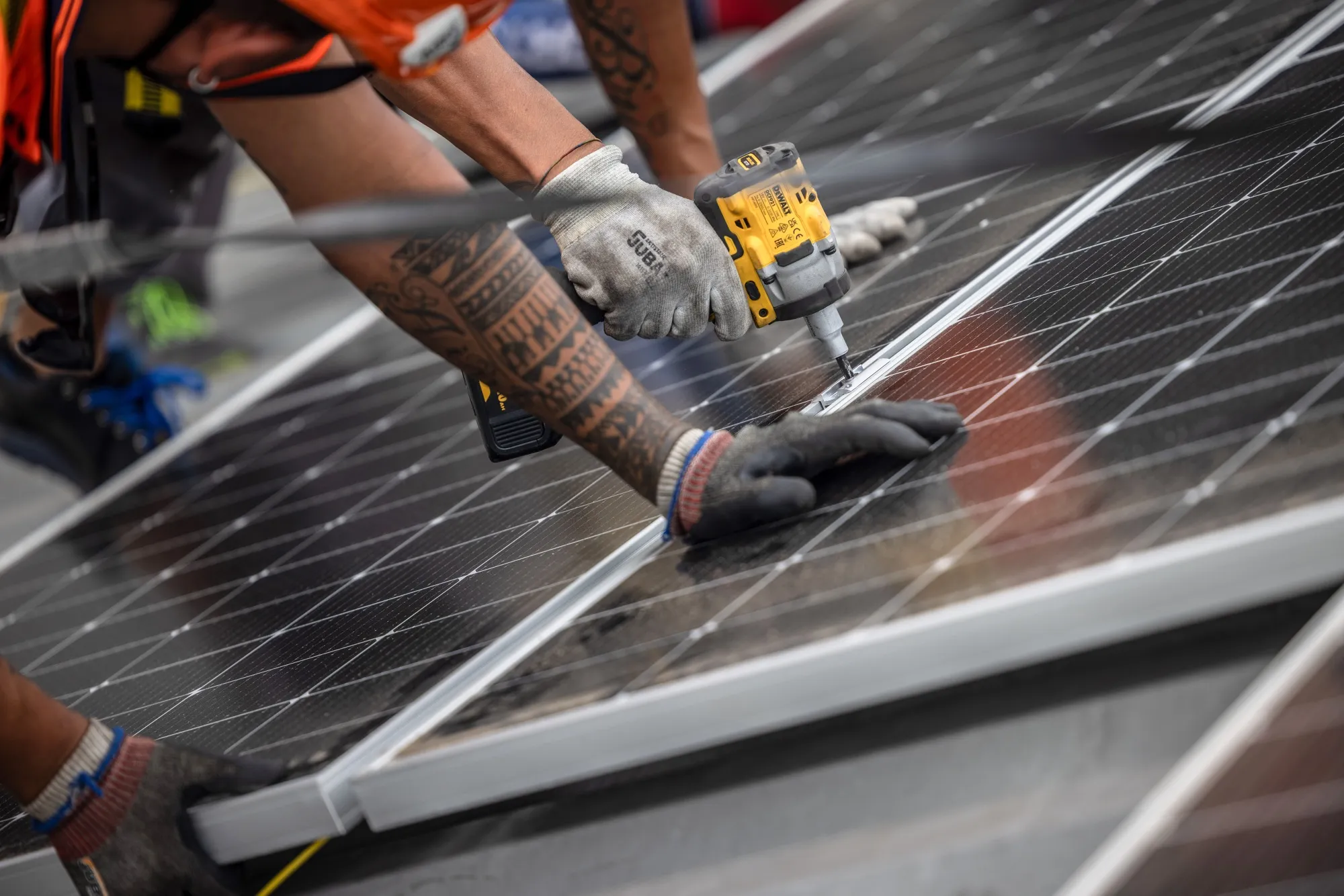 Workers install a solar panel in Barcelona.
