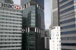 The HSBC Building, left, stands next to commercial buildings in Singapore.
