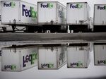 FedEx Ground trucks&nbsp;parked outside of a distribution center.
