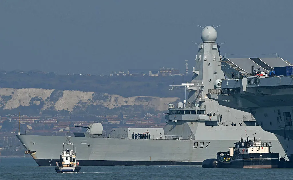 HMS Duncan, a Royal Navy Type 45 Daring-class air-defense destroyer, passes the aircraft carrier HMS Prince of Wales in Portsmouth. One thing these ships have in common is neither is being sent to open the Strait of Hormuz.
