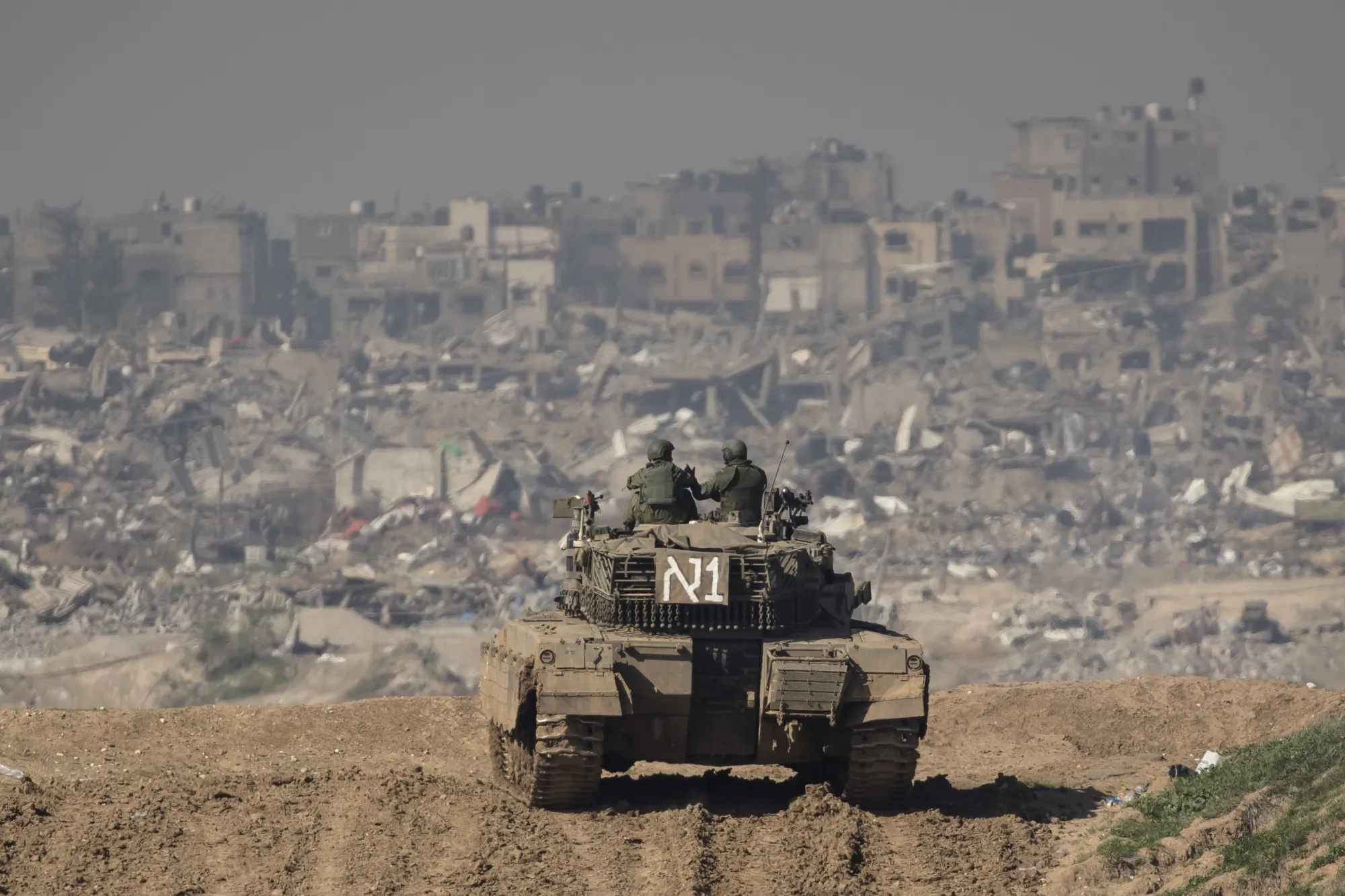 Israeli soldiers look on from a tank as they secure the border with the Gaza Strip&nbsp;in&nbsp;Israel on Jan. 19.