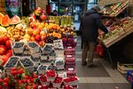Customers browse fresh fruit stalls at a market in Warsaw.