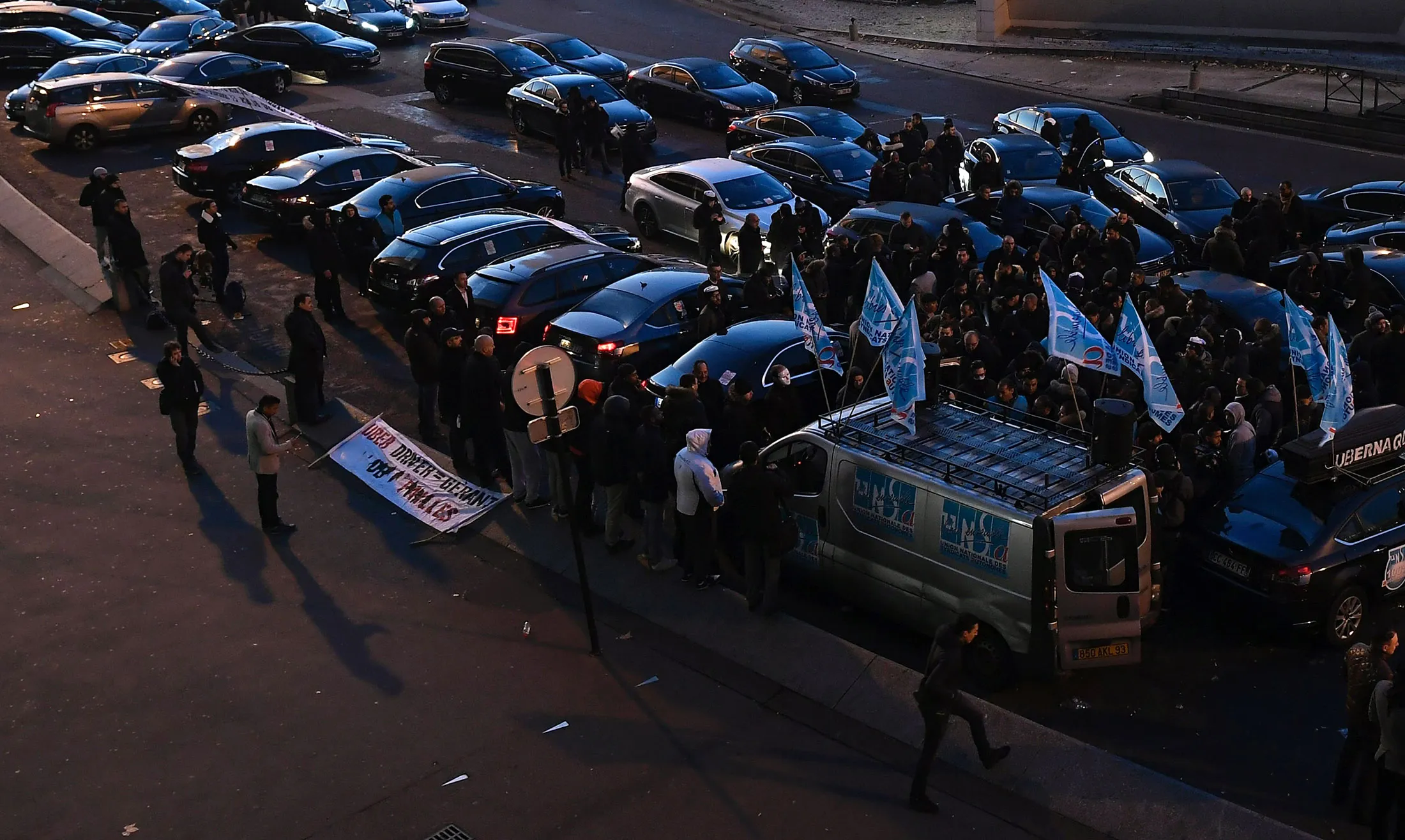 Ride-hailing drivers gather at the Porte Maillot in Paris on Dec. 15, 2016.
