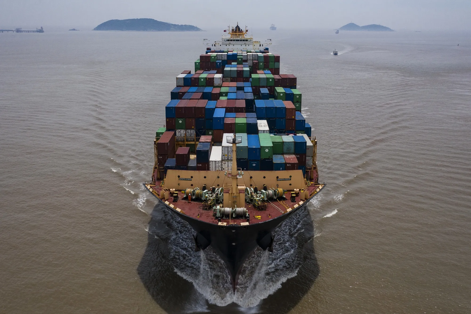A vessel loaded with shipping containers approaches the Yangshan Deepwater Port in&nbsp;Shanghai.
