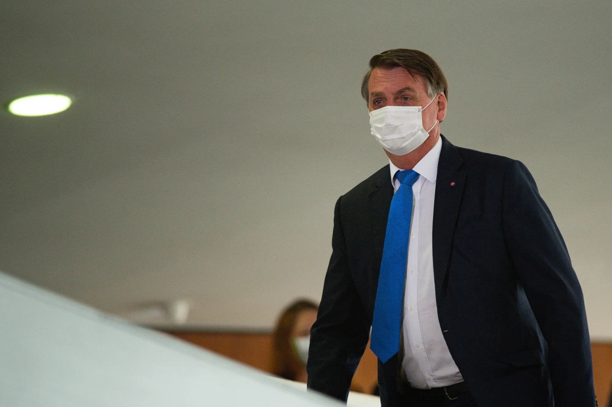 President Jair Bolsonaro wears a protective mask after speaking at a news conference at presidential palace on March 31, 2021.