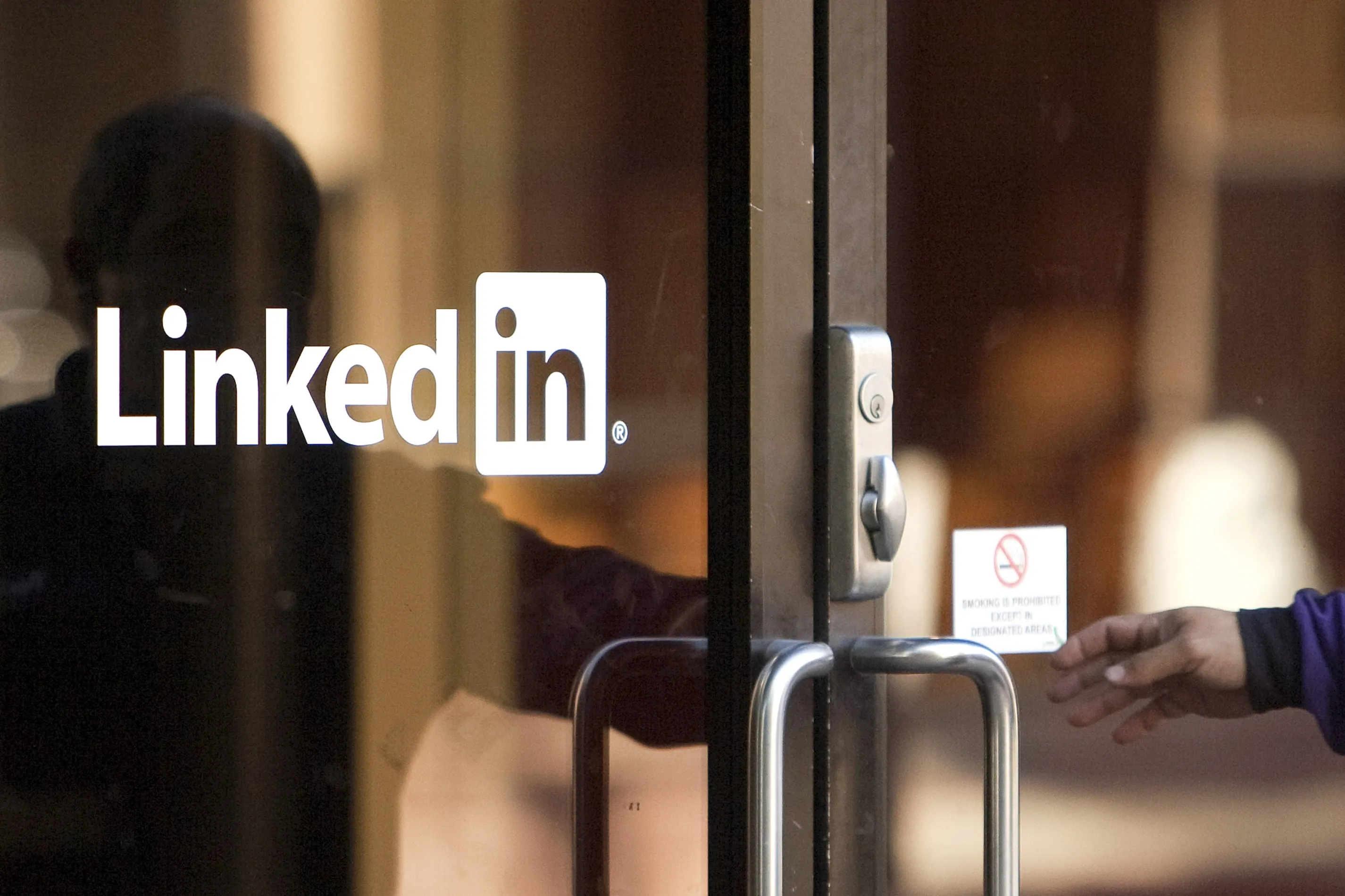 A man enters&nbsp;LinkedIn headquarters in Mountain View, California,.

