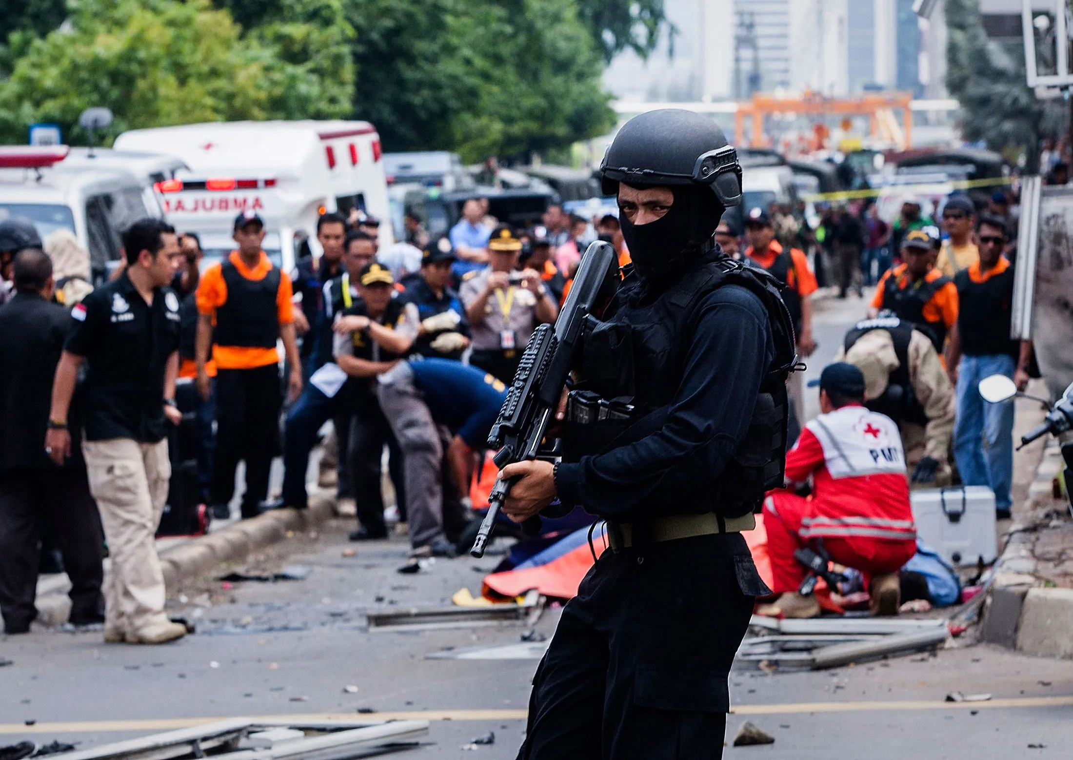 An Indonesian policeman stands guard in front of a blast site at the Indonesia capital Jakarta on January 14, 2016 in Jakarta, Indonesia.
