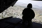 A U.S. soldier mans a gun at the back gate aboard a helicopter in Kabul, Afghanistan on April 24, 2017.