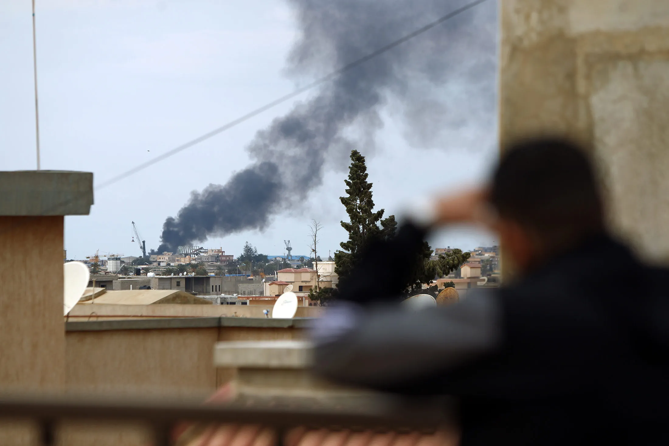 Smoke rises from the port of the eastern Libyan city of Benghazi on Feb. 14, 2015, during clashes between forces loyal to the internationally recognised government and Islamist militias.
