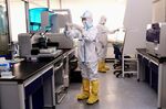 Laboratory technicians work on testing samples from people to be tested for the COVID-19 coronavirus at a laboratory in Shenyang in China's northeastern Liaoning province on Feb. 12, 2020.