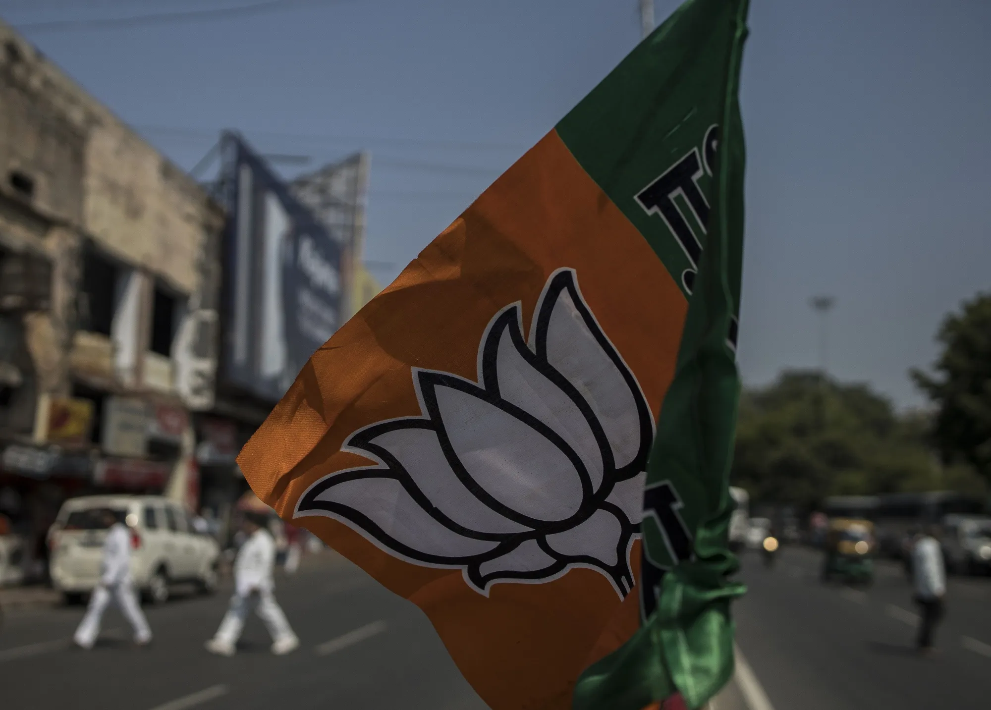A Bharatiya Janata Party flag flies from a traffic barrier in Lucknow, Uttar Pradesh, India.
