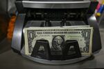 US dollar banknotes counted by a cash counting machine at a currency exchange in New Delhi, India, on Saturday, Aug. 30, 2025. The Indian rupee slumped to a record low versus the dollar on concern that 50% US tariffs will hurt the country's economic growth and corporate earnings.