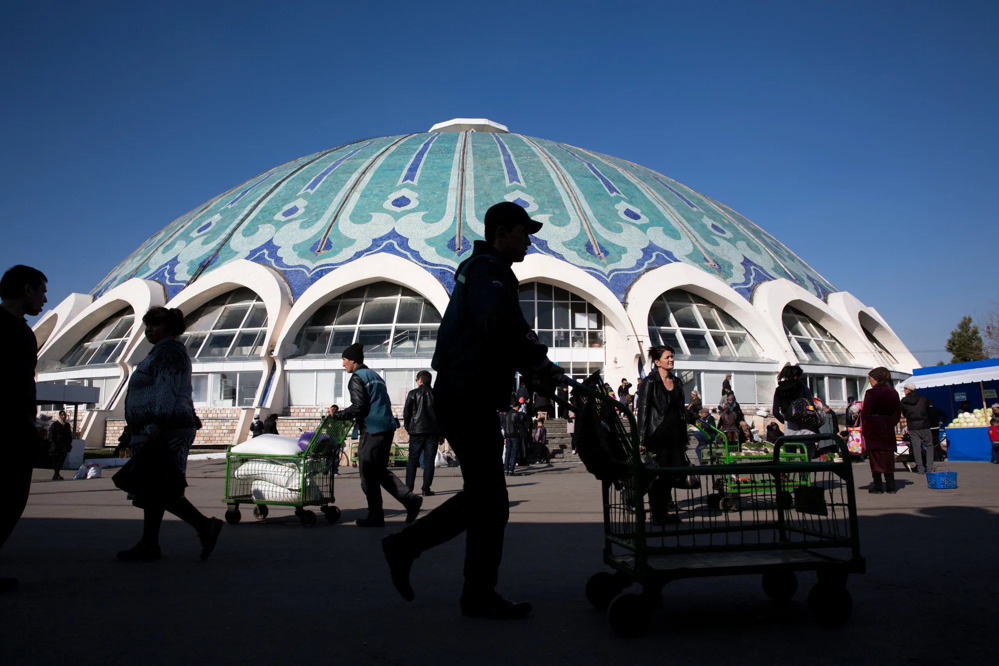 Shoppers walk outside of Chorsu Bazaar in Tashkent, Uzbekistan.