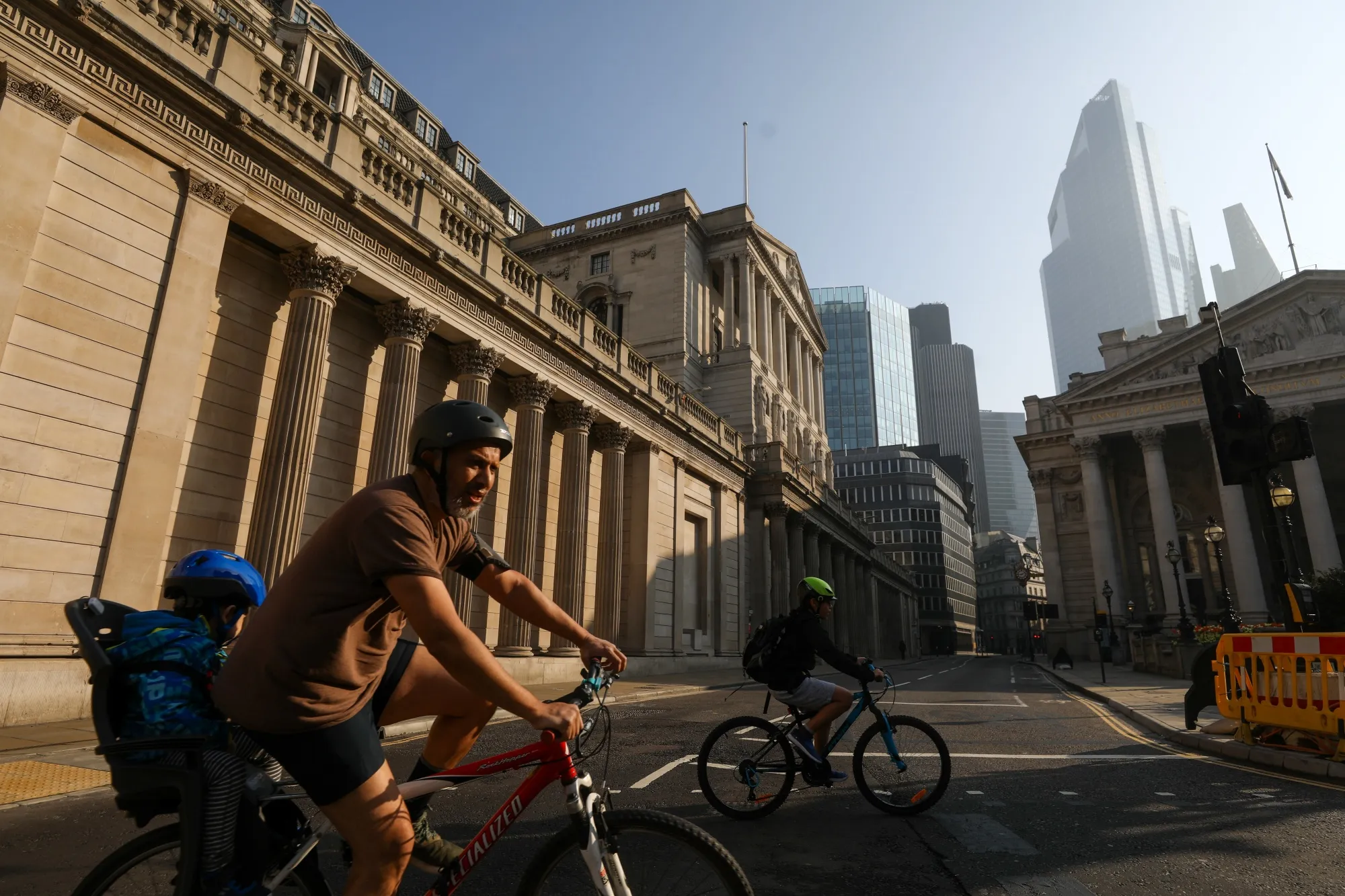Cyclists pass the Bank of England in the City of London, U.K., on Thursday, April 9, 2020. U.K. Prime Minister Boris Johnson spent a third night in the critical care unit where his condition is improving, as officials draw up plans to extend the lockdown in an bid to control the U.K.’s growing coronavirus crisis.