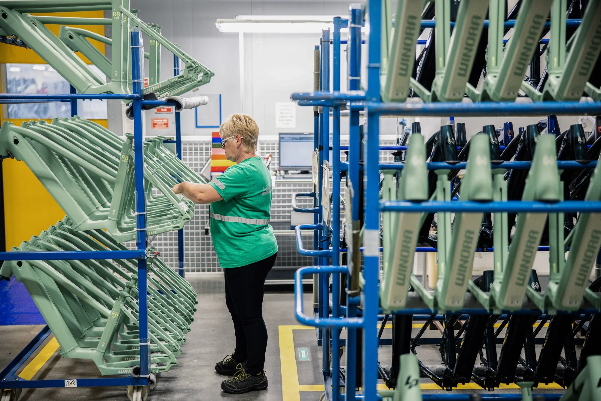 An employee inspects painted Winora bicycle frames on the e-bike assembly line at the Accell Hunland Kft plant in Toszeg, Hungary, in 2022.