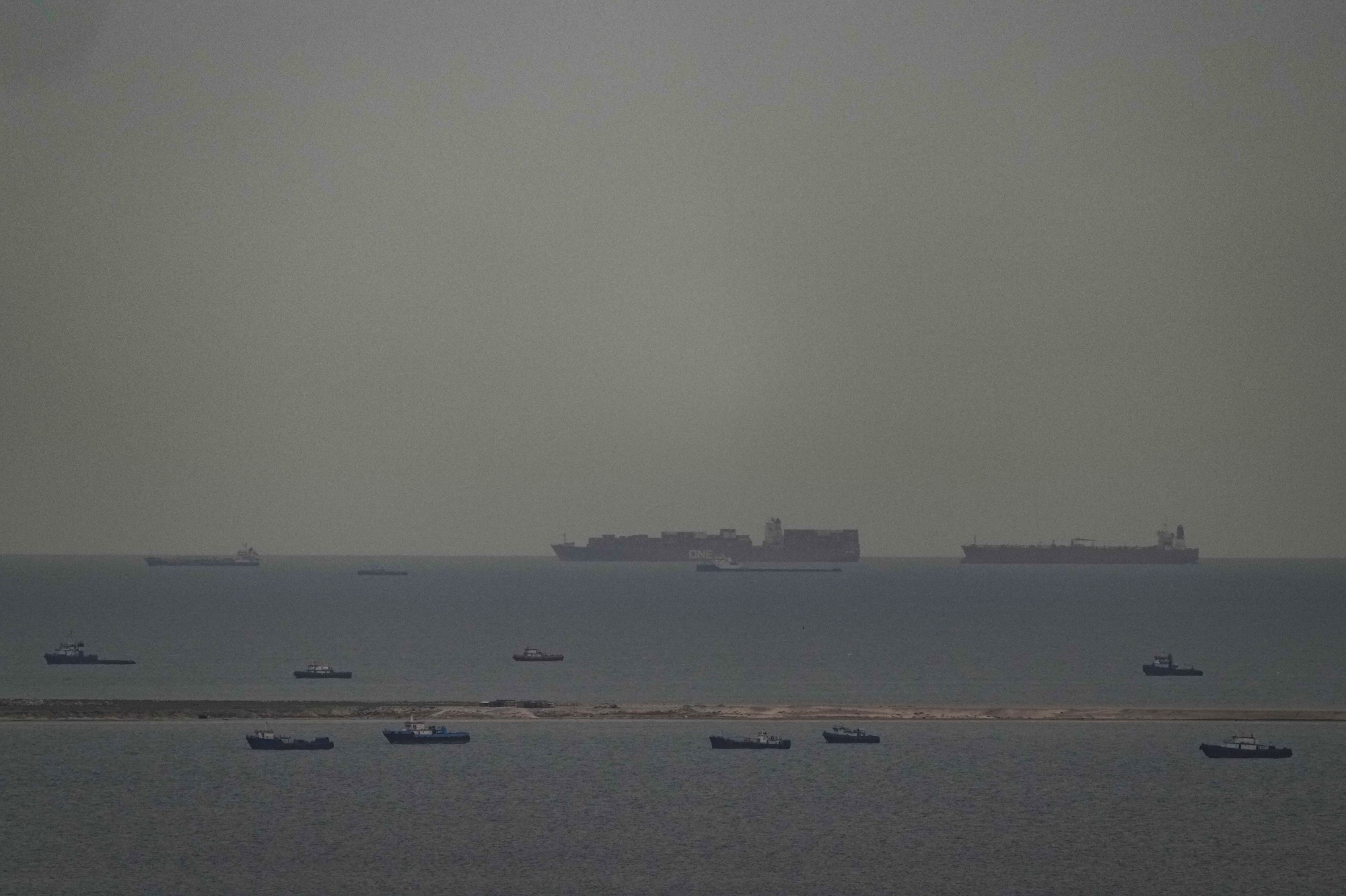 Cargo ships in the Arabian Gulf move toward the Strait of Hormuz off the United Arab Emirates on March 27. AP