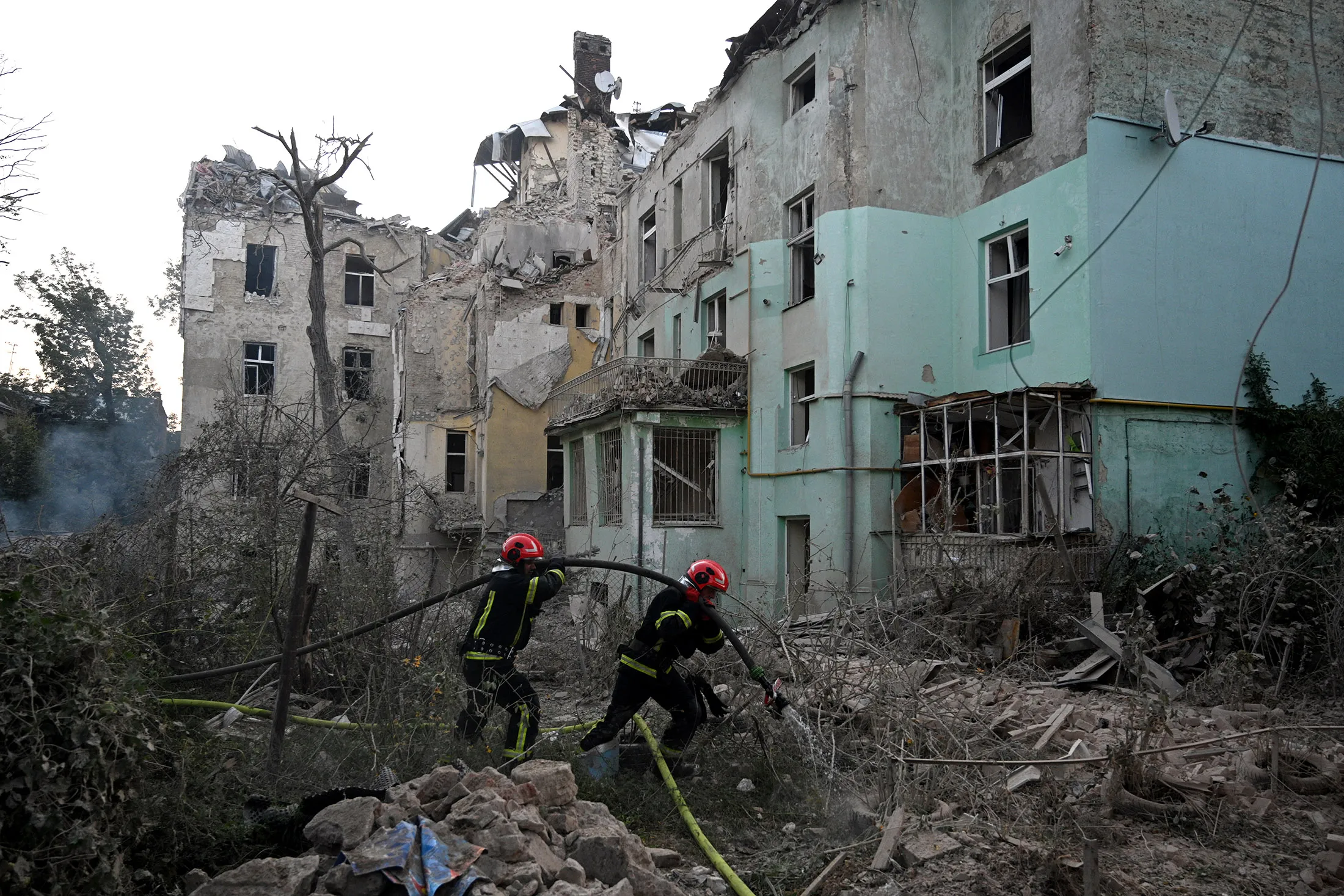 Ukrainian rescuers work at the site of a missile strike in Lviv on Sept.