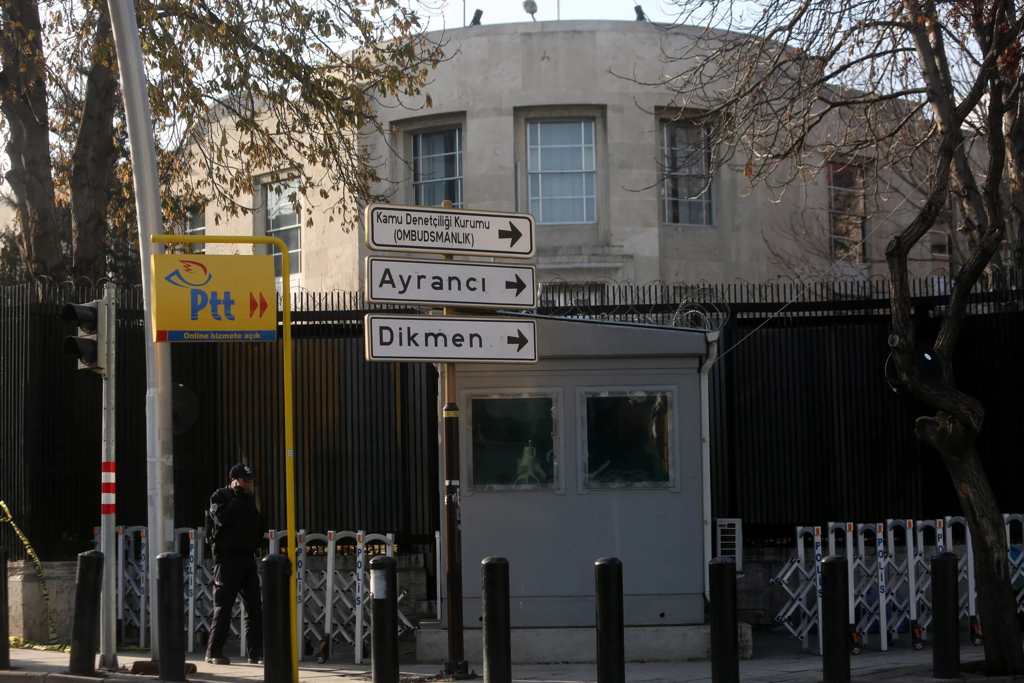 A Turkish special police officer stands guard outside the perimeter fence of the U.S. embassy in Ankara.