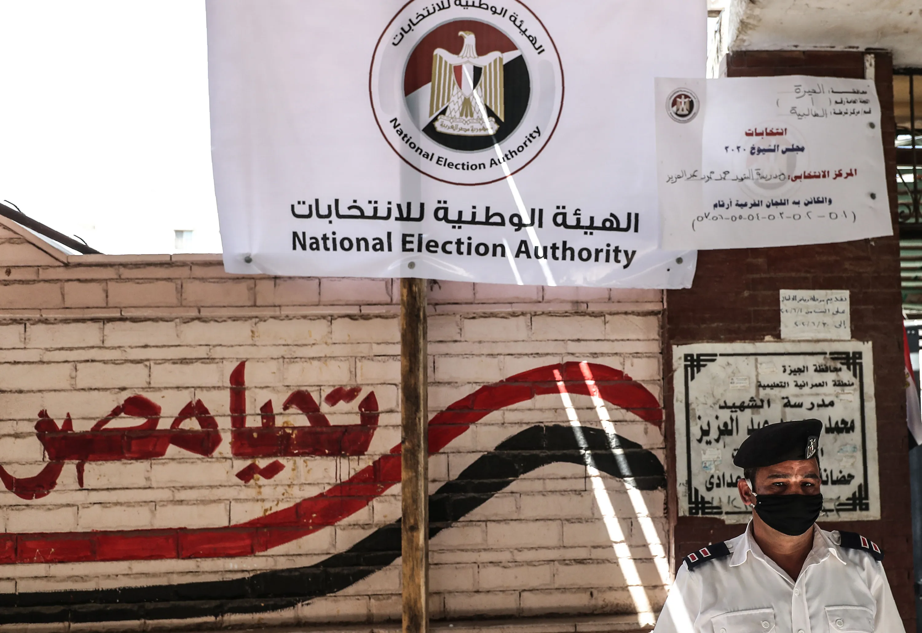 An Egyptian policeman stands outside a polling station on Aug. 11.