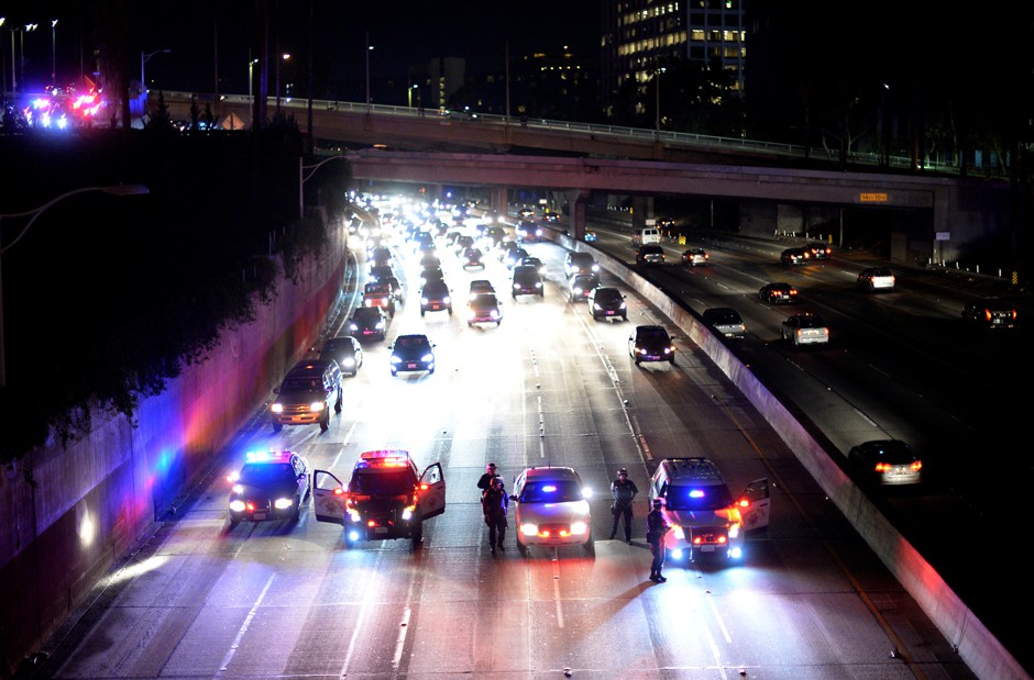 California Highway Patrol officer stop the flow of traffic on the 110 freeway as protesters unsuccessfully attempted to rush the freeway in a November 11, 2016, rally to oppose the election of President Donald Trump.