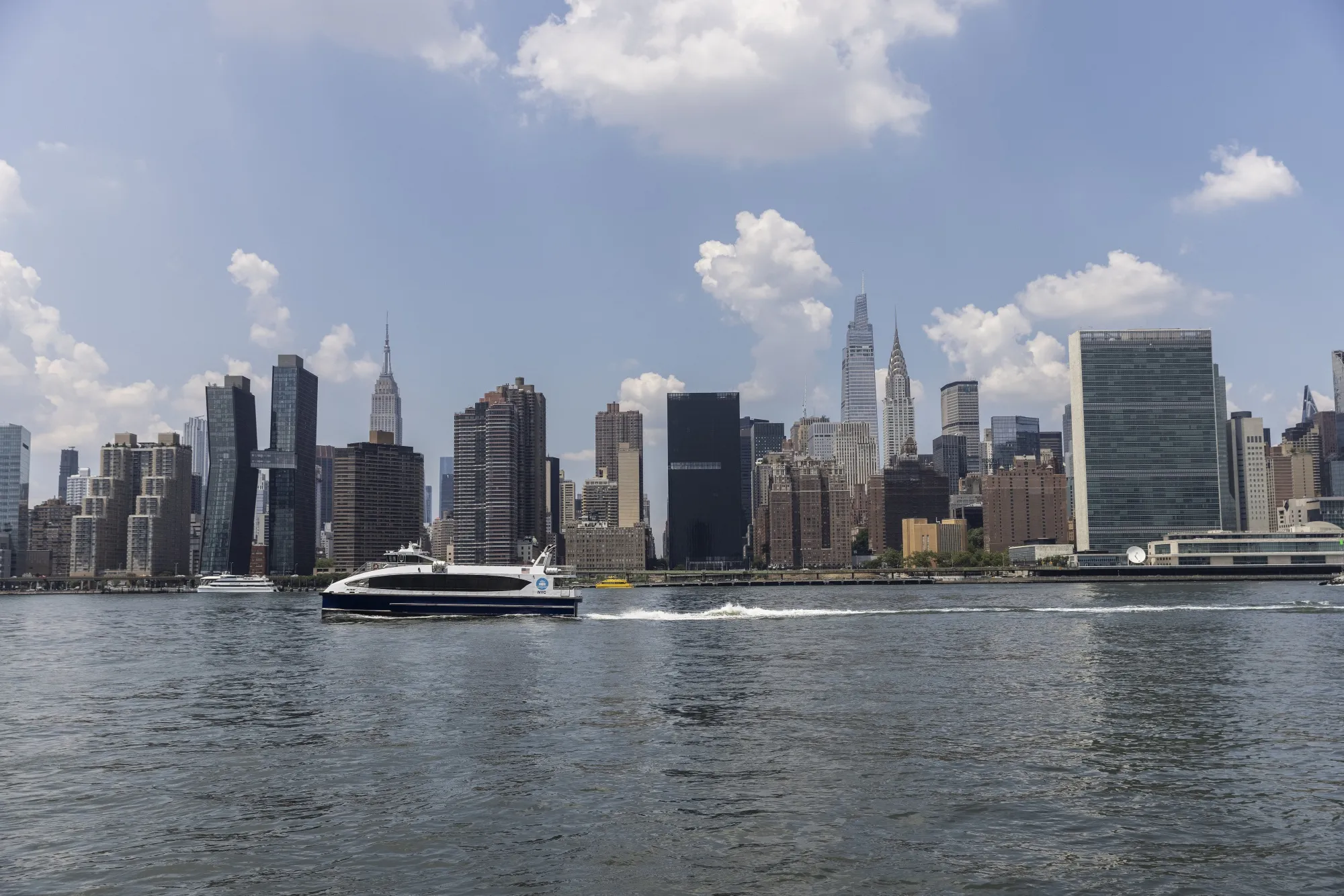 A NYC Ferry travels on the East River during a heat wave in July,&nbsp;2022.&nbsp;