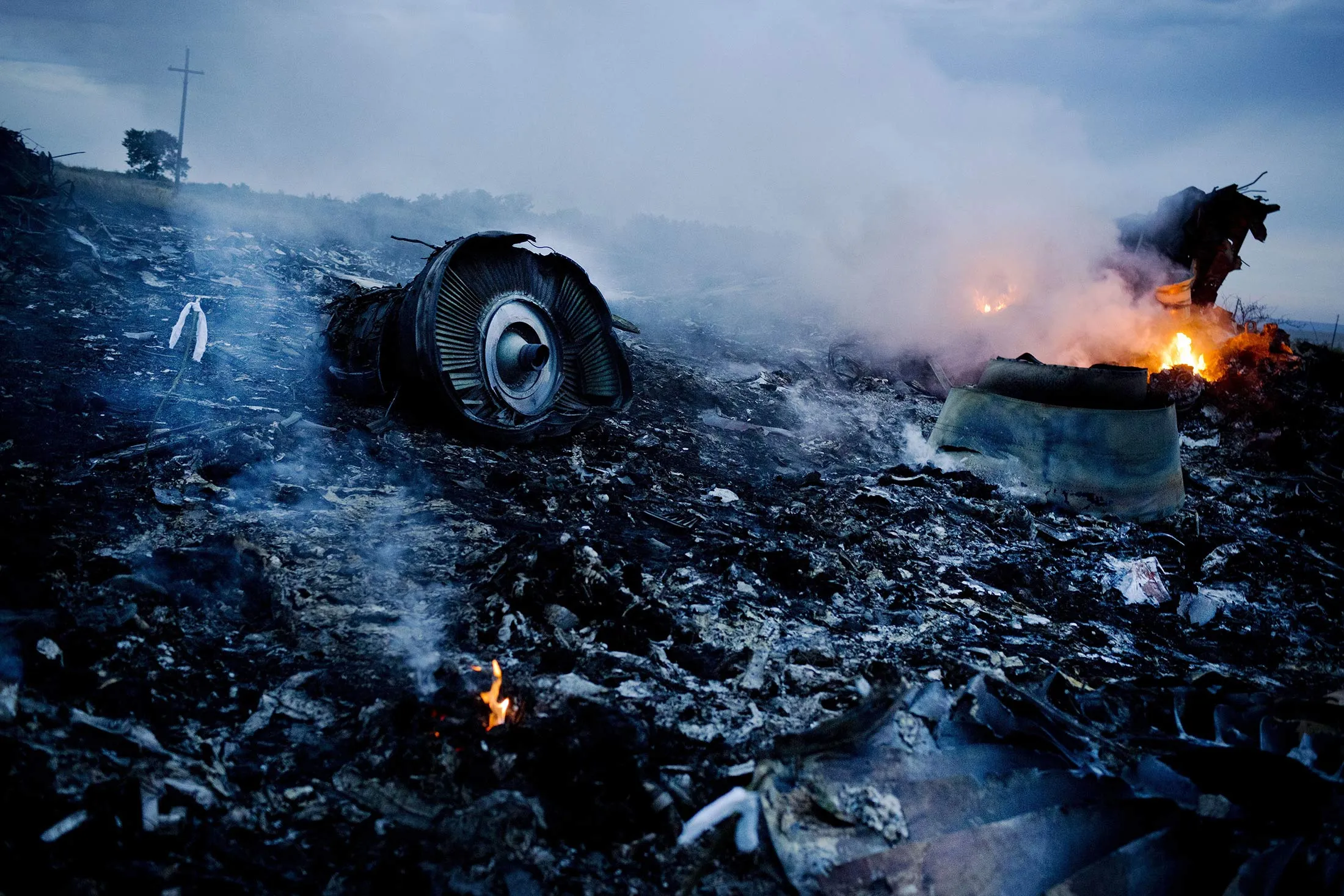 Debris from Malaysia Airlines Flight 17 is shown smouldering in a field in Grabovo, Ukraine, on&nbsp;July 17, 2014.
