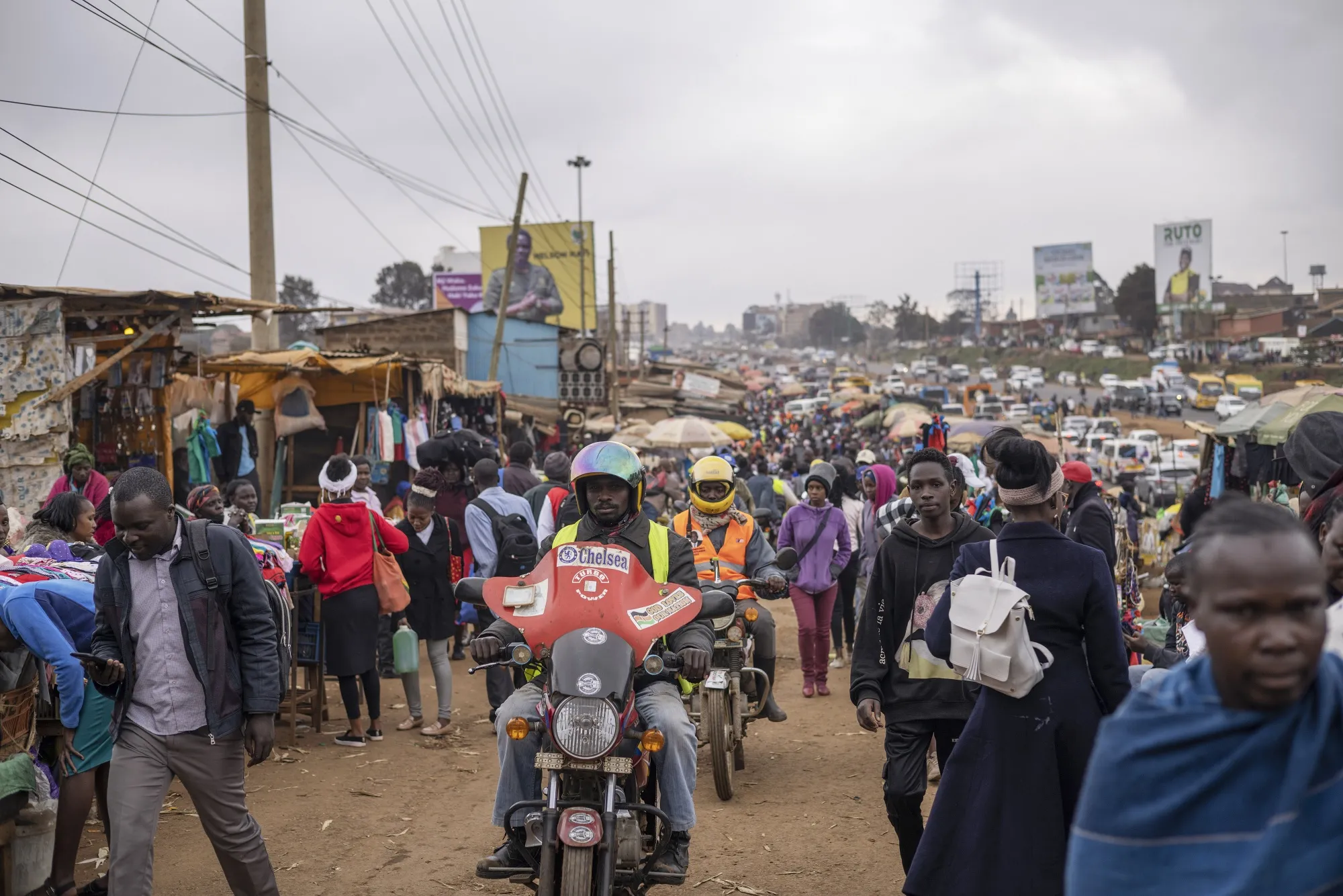 Motorcycle taxis&nbsp;ride&nbsp;through a busy street market in the Kangemi district of Nairobi, Kenya, on Aug. 1, 2022.&nbsp;